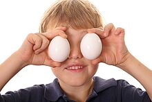 Junge hält zwei Eier vor seinen Augen (Quelle: Thinkstock)